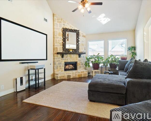 A living room with a fireplace and a large mirror above it.