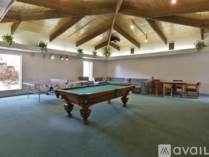A room with a pool table and a ping pong table.