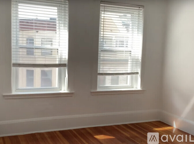 Two windows with blinds open to a bright day.