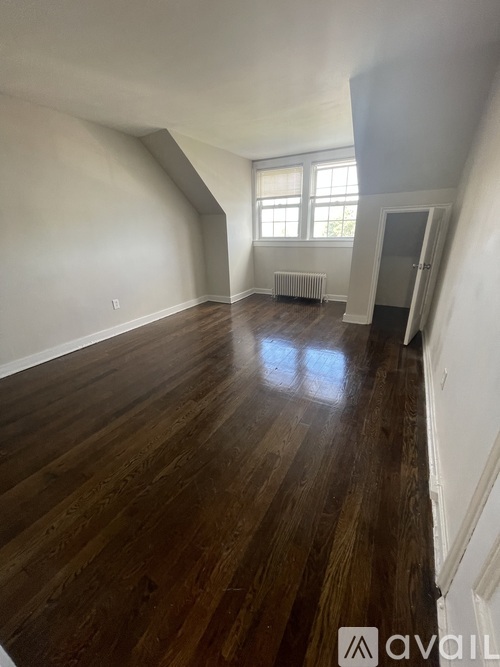 A room with wooden floors and a window.