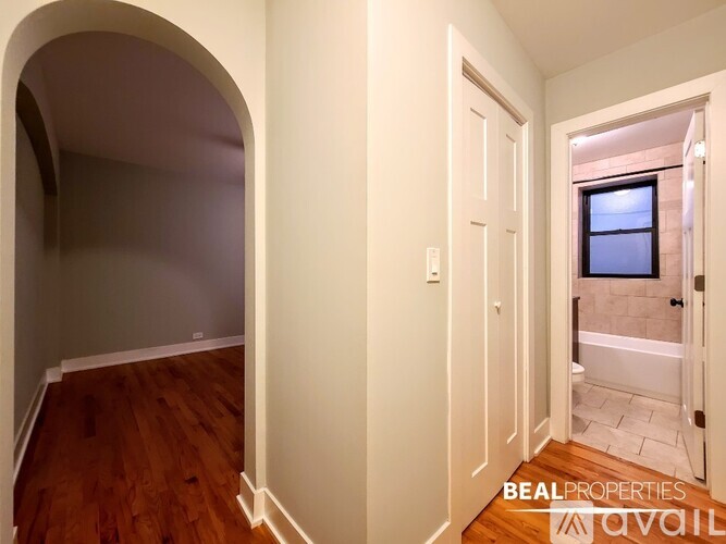 A room with a doorway leading to a bathroom.
