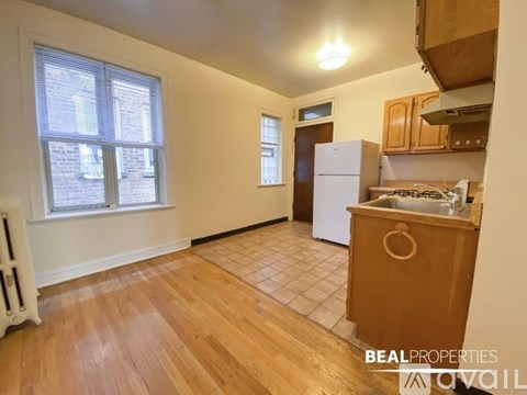 A kitchen with wooden floors and white appliances.