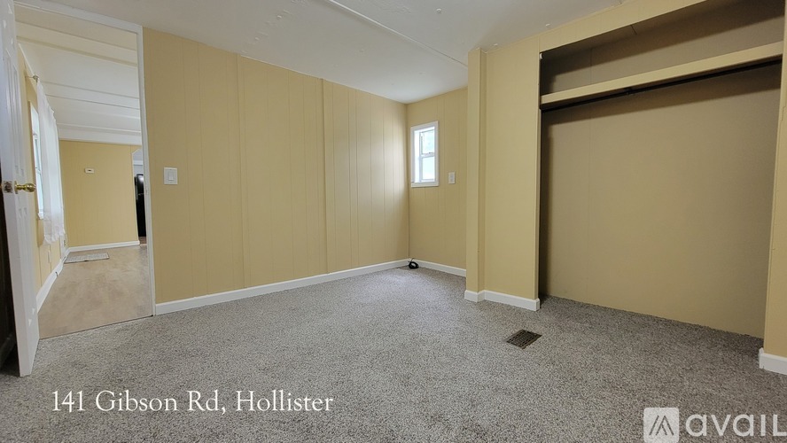 A room with beige walls and carpeted floor at 141 Gibson Rd, Hollister.