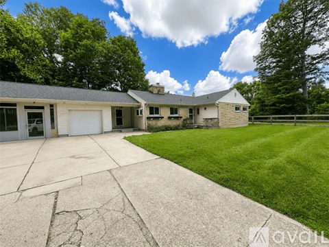 A house with a driveway in front of it.