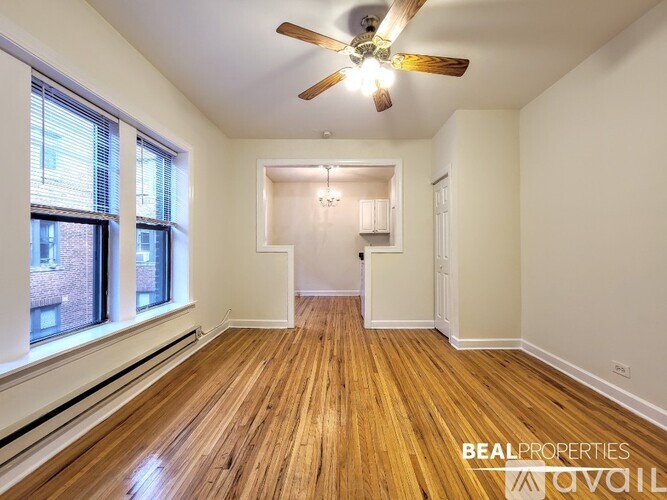 A room with wooden floors and a ceiling fan.