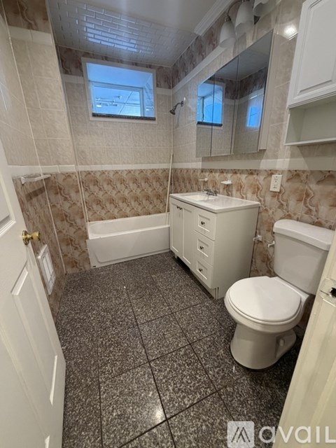 A bathroom with a toilet, sink, and bathtub.