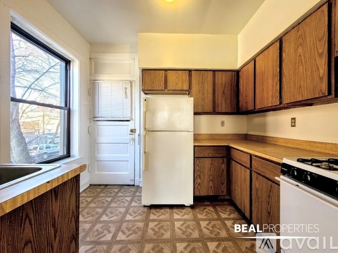 A kitchen with a white fridge and a white stove.
