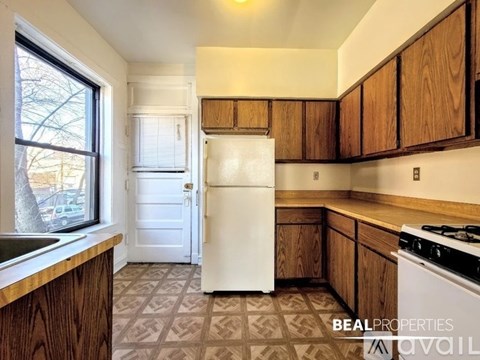A kitchen with a white fridge and a white stove.