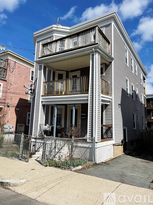 A two-story house with a balcony on the second floor.