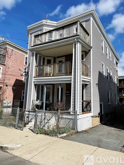 A two-story house with a balcony on the second floor.