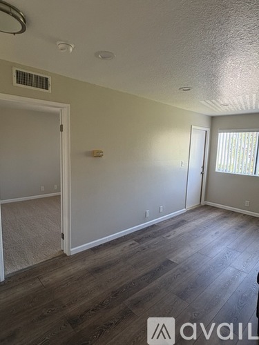 A room with a wooden floor and white walls.