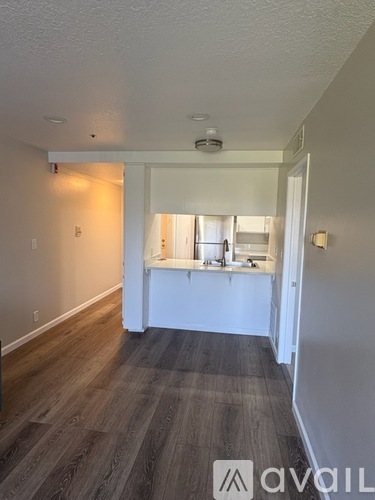 A room with a kitchenette and a window.