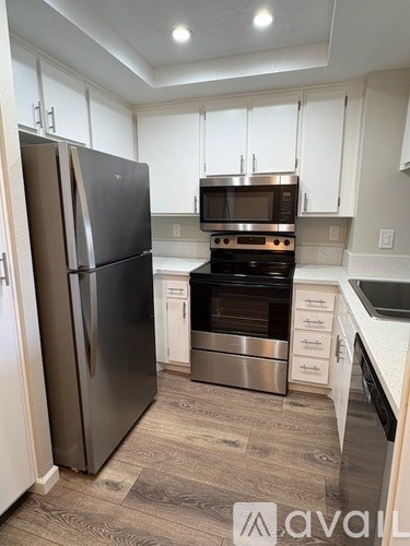 A kitchen with a stainless steel refrigerator and oven.