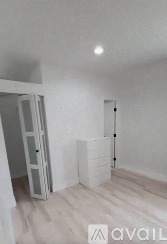 A room with a white door and a white cabinet.