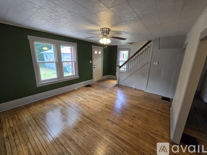 A room with wooden floors and a staircase.