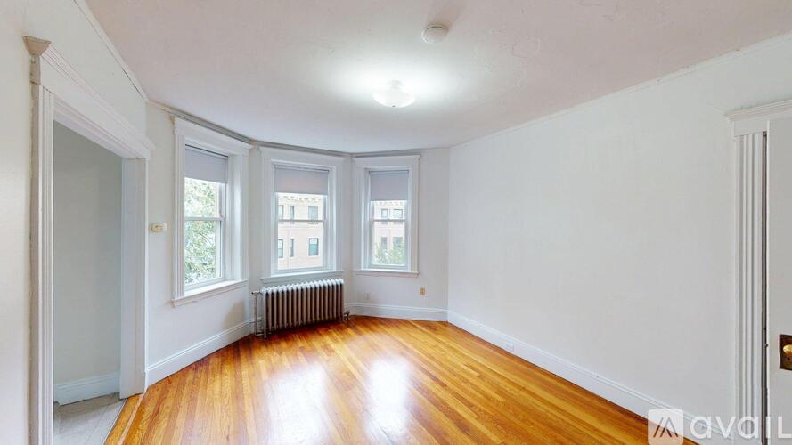 A room with wooden floors and white walls.