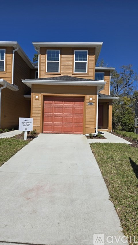 A house with a brown garage door is for sale.