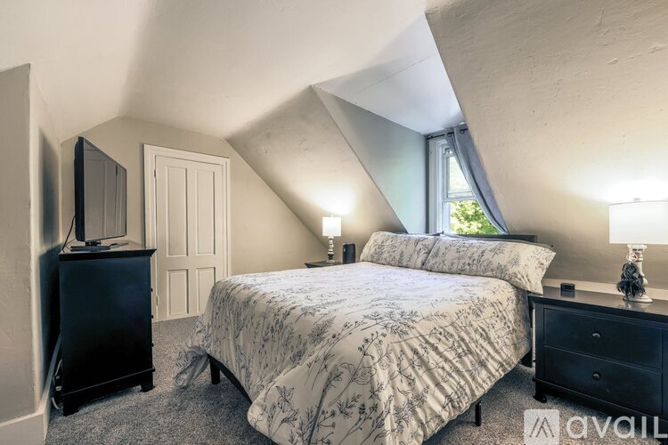 A bedroom with a large bed and a television.