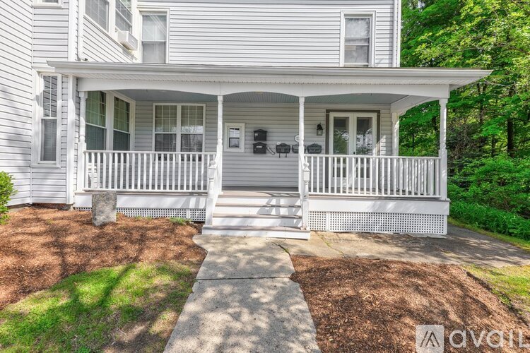 A house with a porch and a front yard.