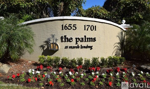 A sign for The Palms at Marsh Landing with a date range and palm tree logo.