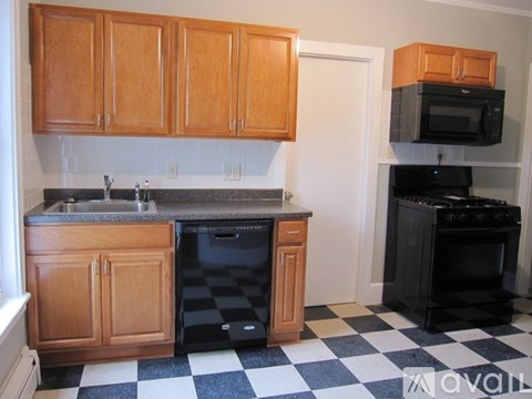 A kitchen with black and white checkered floor.