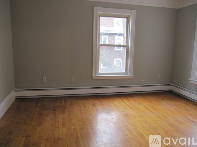 A room with a wooden floor and a window.