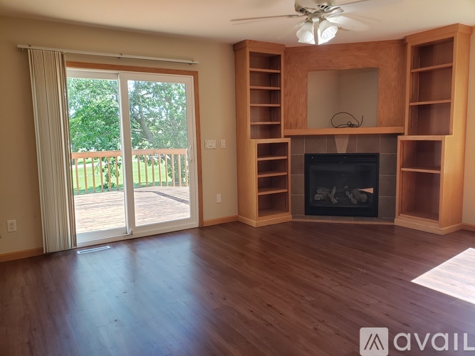 A living room with a fireplace and sliding glass doors.