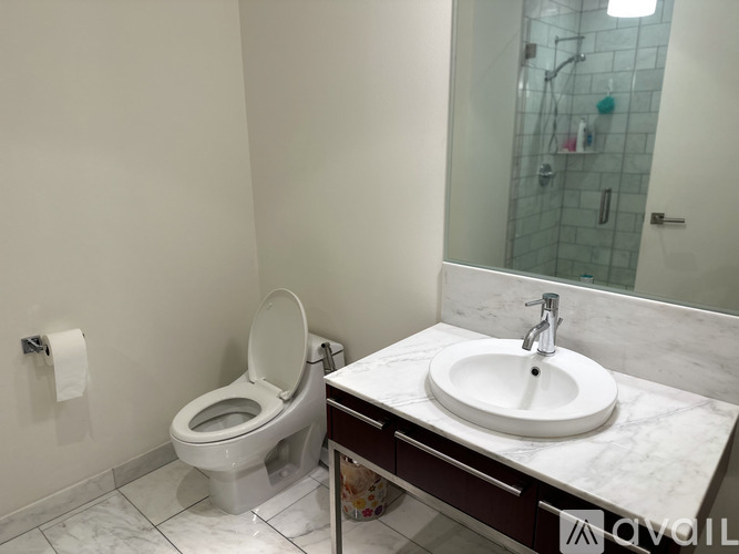 A white toilet sits next to a sink in a bathroom.