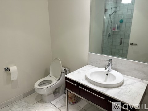 A white toilet sits next to a sink in a bathroom.