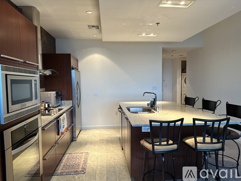 A kitchen with a sink, stove, and refrigerator.