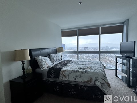 A bedroom with a large bed and a flat screen TV.