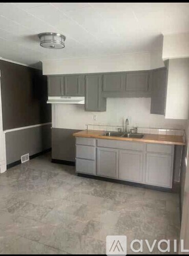 A kitchen with a sink and cabinets.