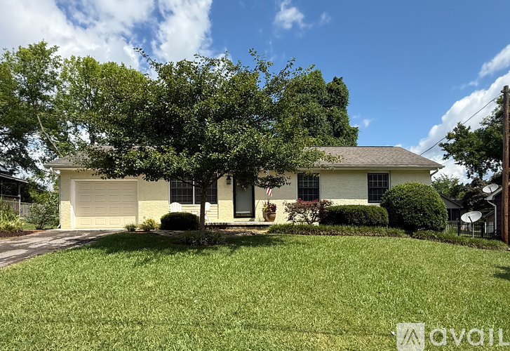 A house with a tree in front of it.