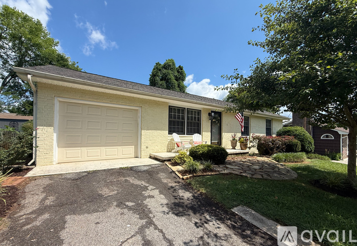 A house with a garage and a flag on the front.