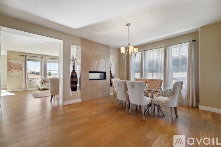 A living room with a white dining table and chairs.