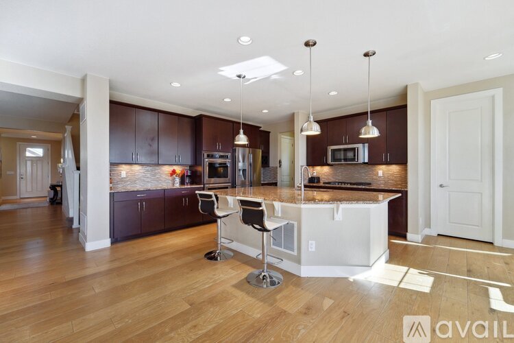 A kitchen with brown cabinets and a white island.