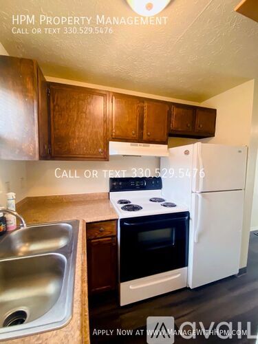 A kitchen with a white refrigerator and a stove top oven.