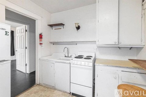 A kitchen with white appliances and cabinets.