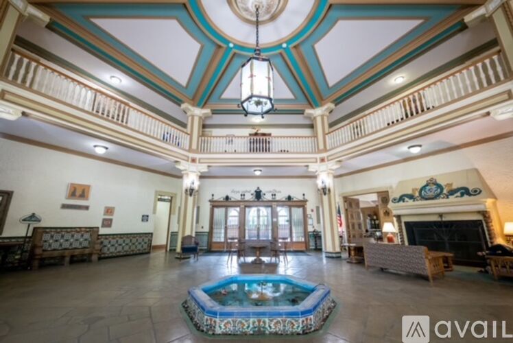 A large room with a pool table and a fireplace.
