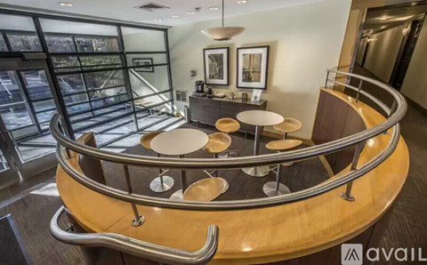 A modern interior space with a circular seating area and a glass wall.