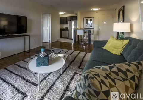 A living room with a green couch and a white coffee table.