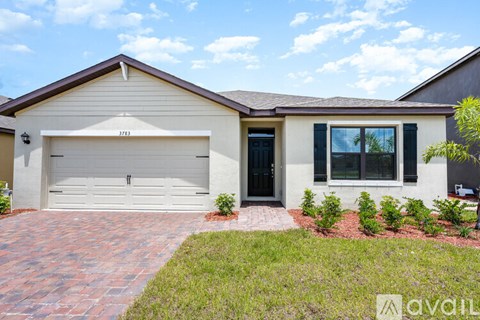 A house with a garage and a driveway in front.
