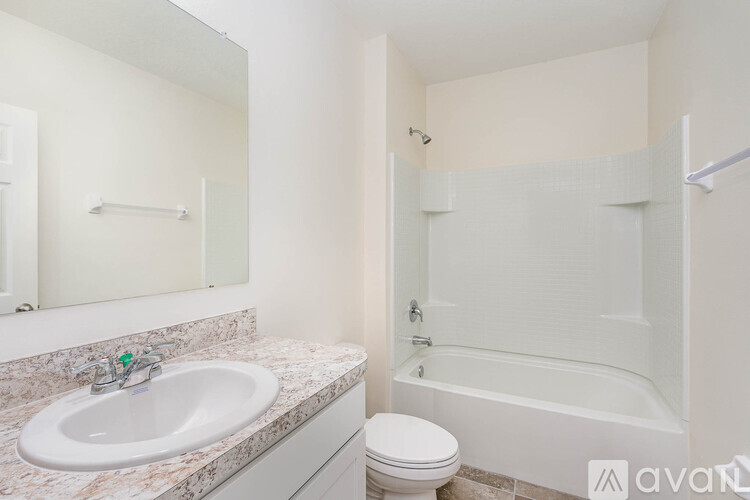 A bathroom with a sink, toilet, and bathtub.