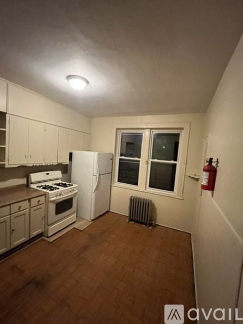 A small kitchen with a refrigerator, stove, and oven.