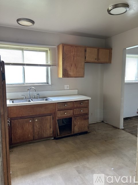 A kitchen with wooden cabinets and a sink.