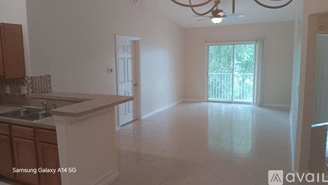 A kitchen with a sink and a chandelier.
