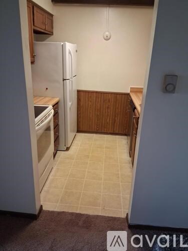 A kitchen with a white fridge and a white oven.