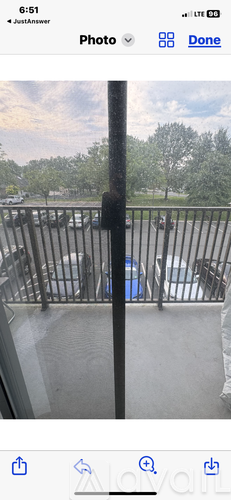 A view from a balcony looking out at a parking lot.
