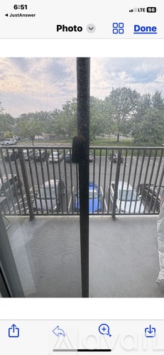 A view from a balcony looking out at a parking lot.