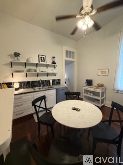 A small dining room with a table and chairs.